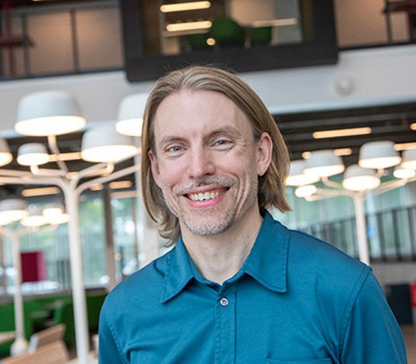 Erik Witte standing indoors in Novahuset.