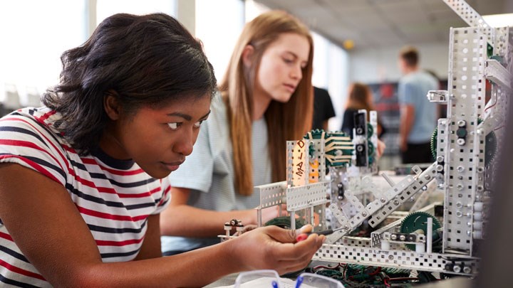 Two girls building with technic.