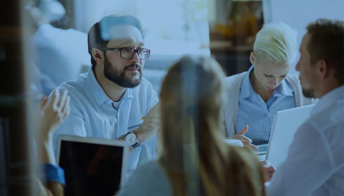 A group of people in meeting.