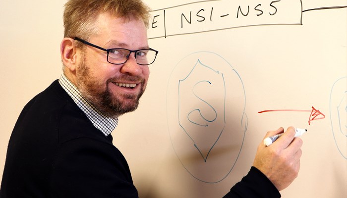 Researcher infront of whiteboard