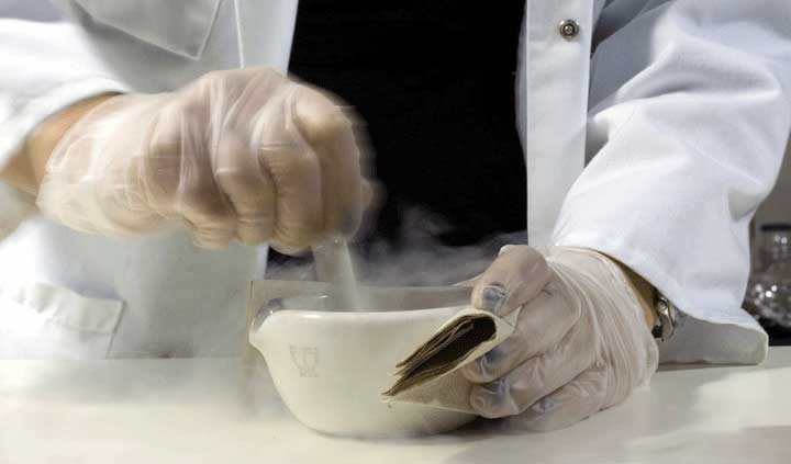scientist stirs in a bowl