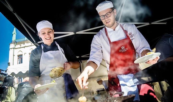 Two chefs cooking food.