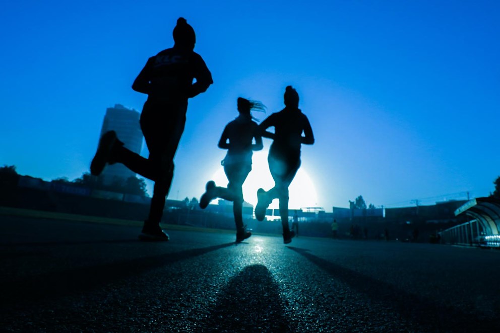 Three people running in the dark
