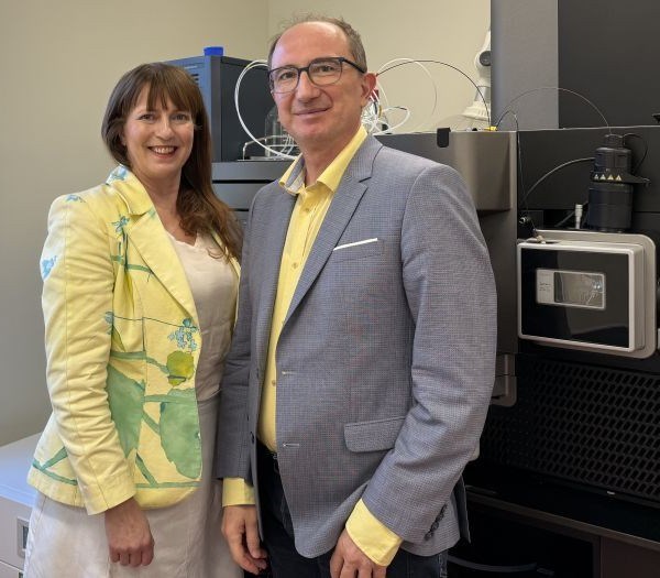 Two researchers in front of laboratory machine