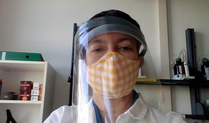 Michaela Zeiner, here in a mask and visor, recording a video in a Vienna laboratory in summer 2020.