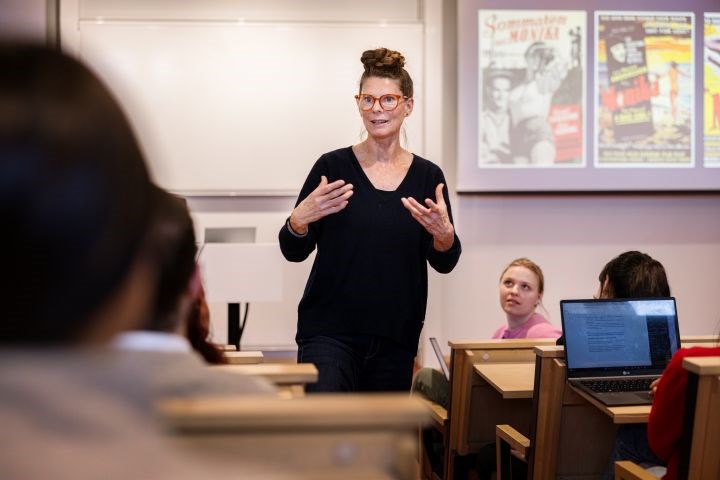 A woman in front of a group of students.
