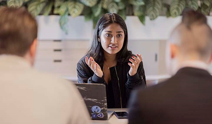 En grupp studenter framför två laptops.