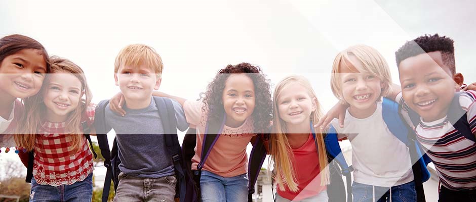 children smiling and having their arms around eacj other