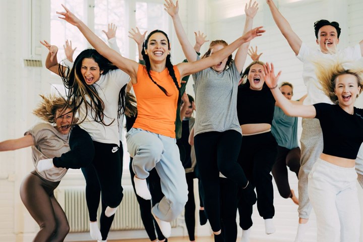People jumping with their arms in the air