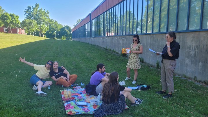 Students sitting on a blanket talking