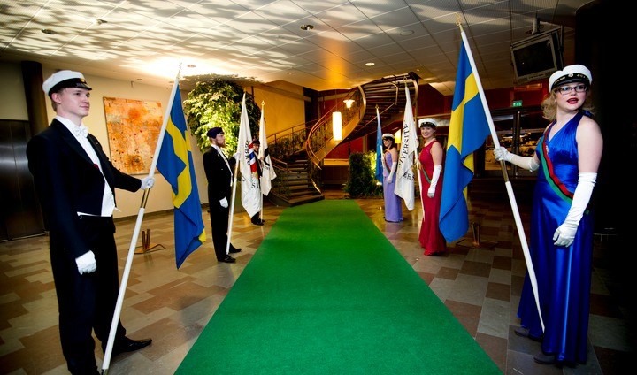 Students holding flags to celebrate new doctors