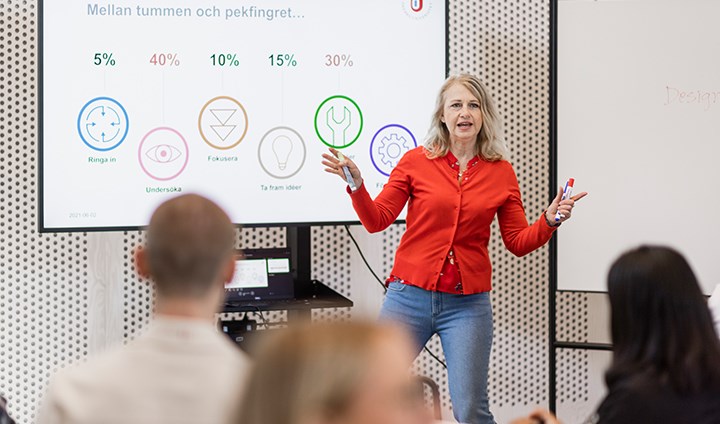 Researcher talking in front of class