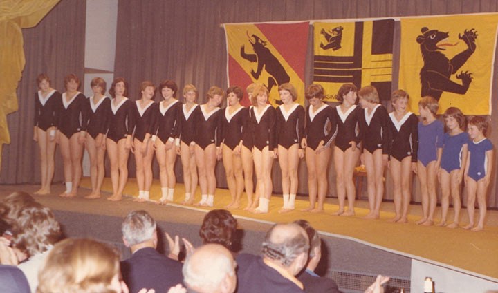 Girl and women  gymnasts on a  stage